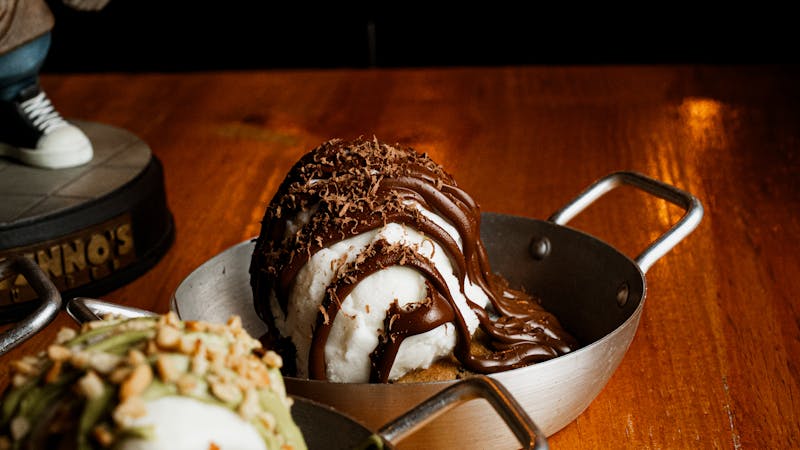 Warm brownie sundae with vanilla ice cream and chocolate drizzle